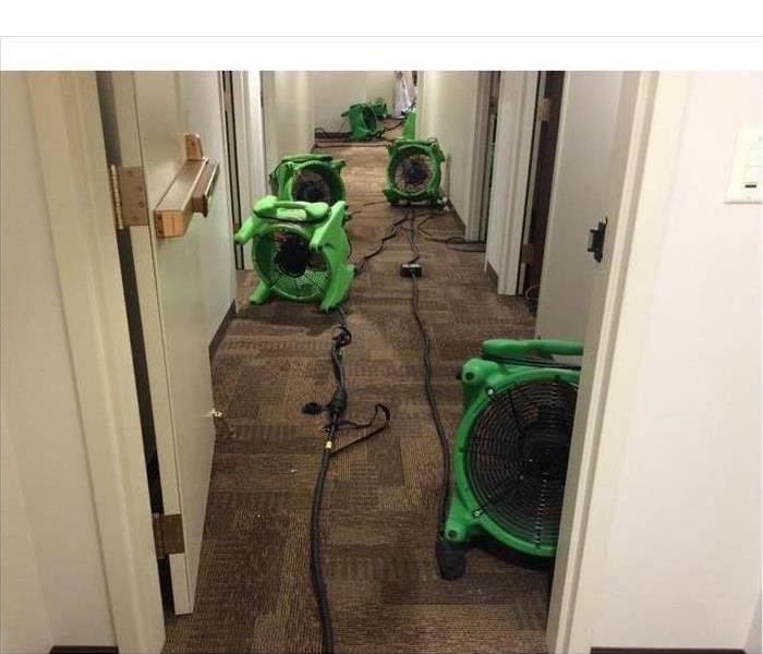 Drying equipment placed on the corridor of a building, drying carpet and walls